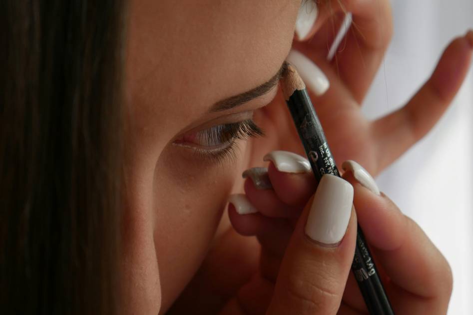 Close-up of perfectly tinted eyebrows with tinting kit tools